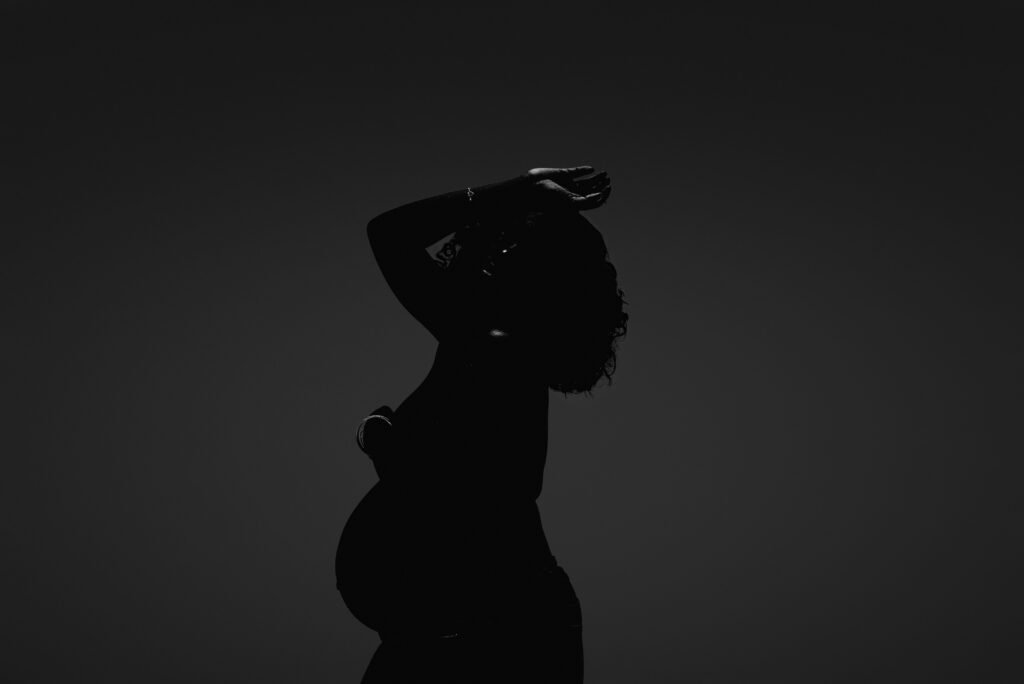 Dramatic maternity silhouette portrait of a pregnant woman in Toronto, CROWNED Motherhood Experience