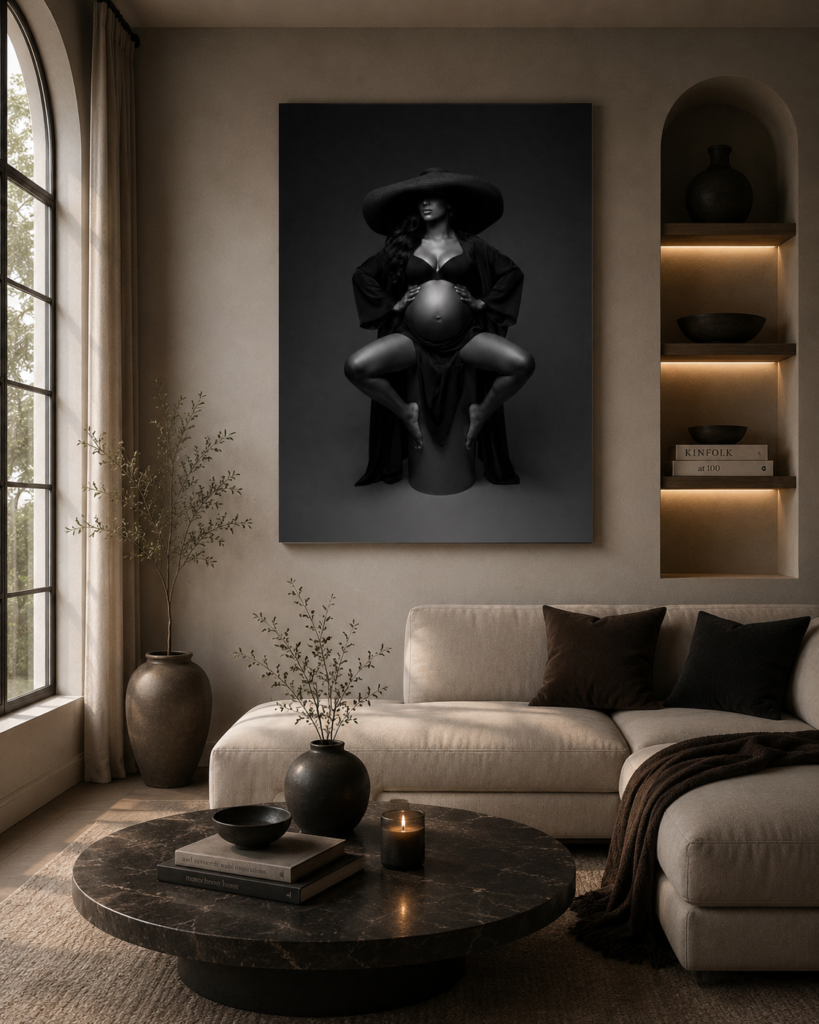 Framed black and white portrait artwork hanging above a sofa in a softly lit living room